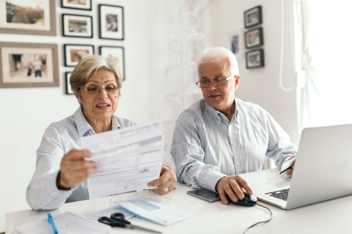 Two Older Adults Paying Bills