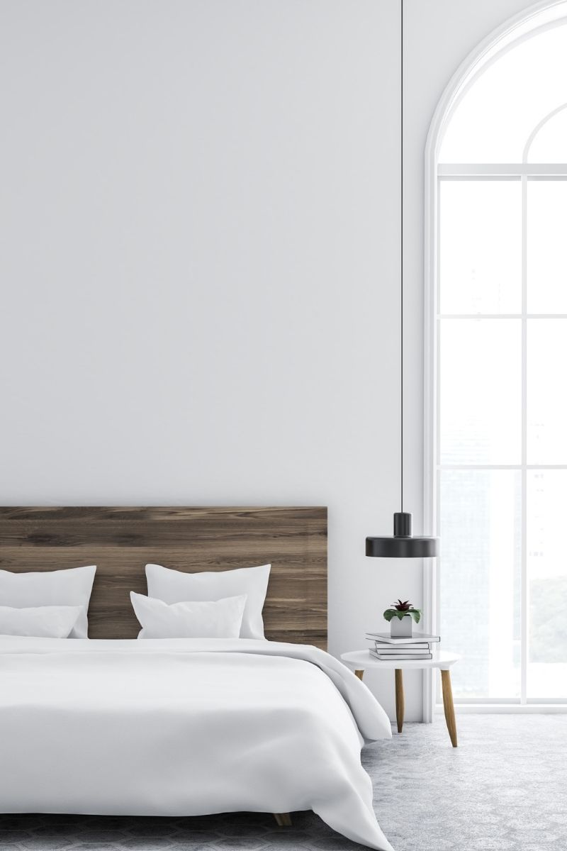 minimal bedroom large window wood headboard