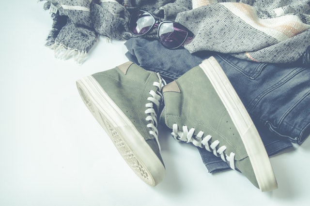 green high-top sneakers beside bottom and sunglasses