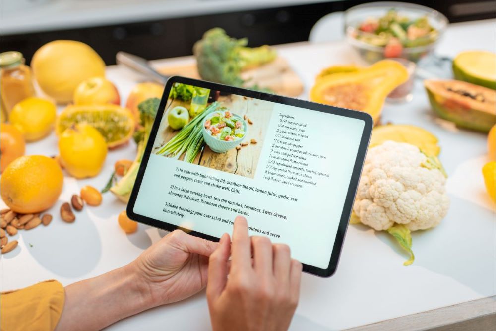 recipe app on ipad fresh vegetables white counter
