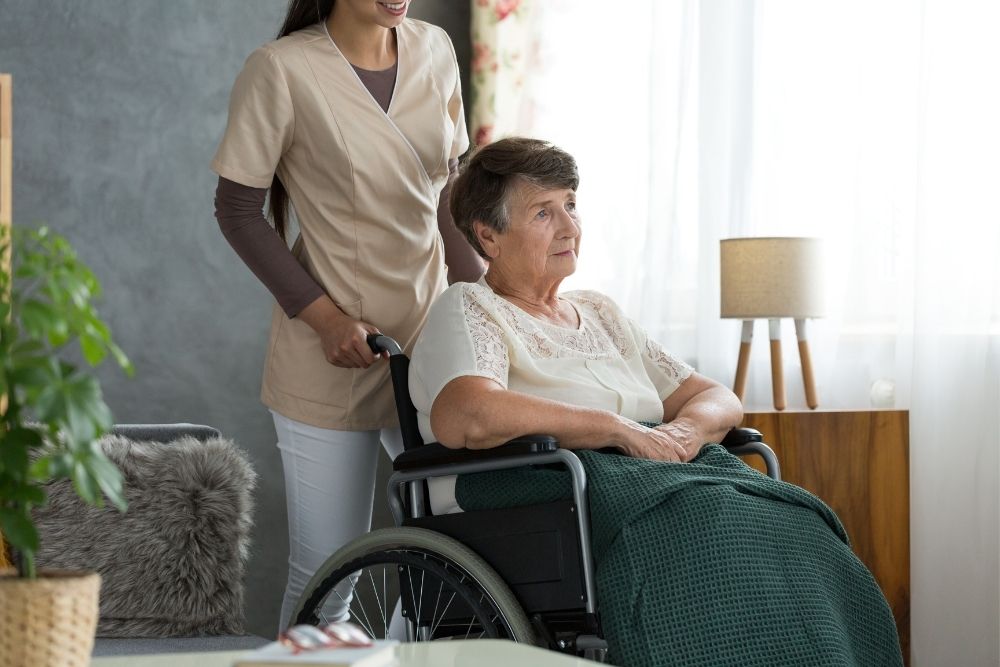 an elderly woman sitting in a wheelchair