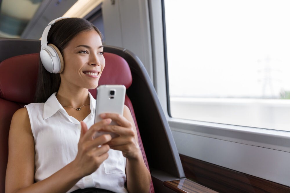 Woman headphones commuting listening to audiobook