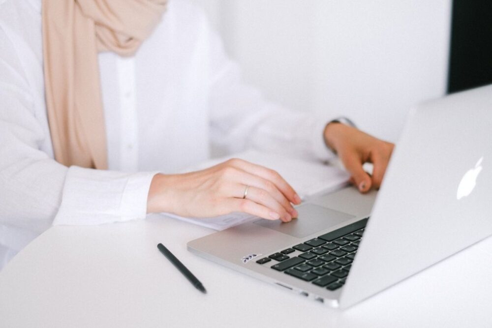 Person in White Dress Shirt Using MacBook Pro