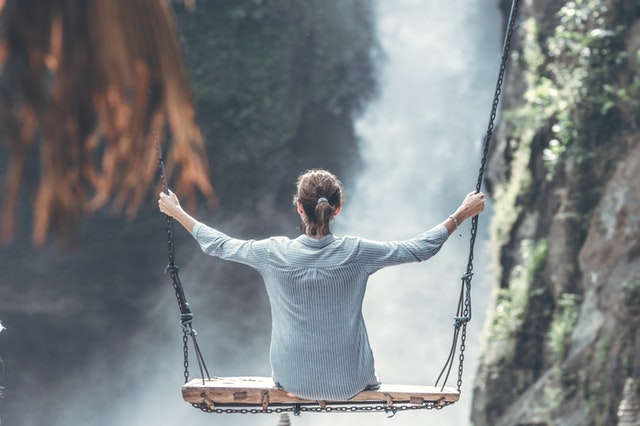 woman on large swing waterfall