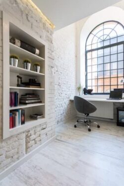 white brick walls home office book shelves