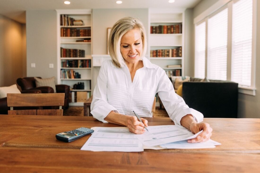 Woman reviewing paperwork on wood table