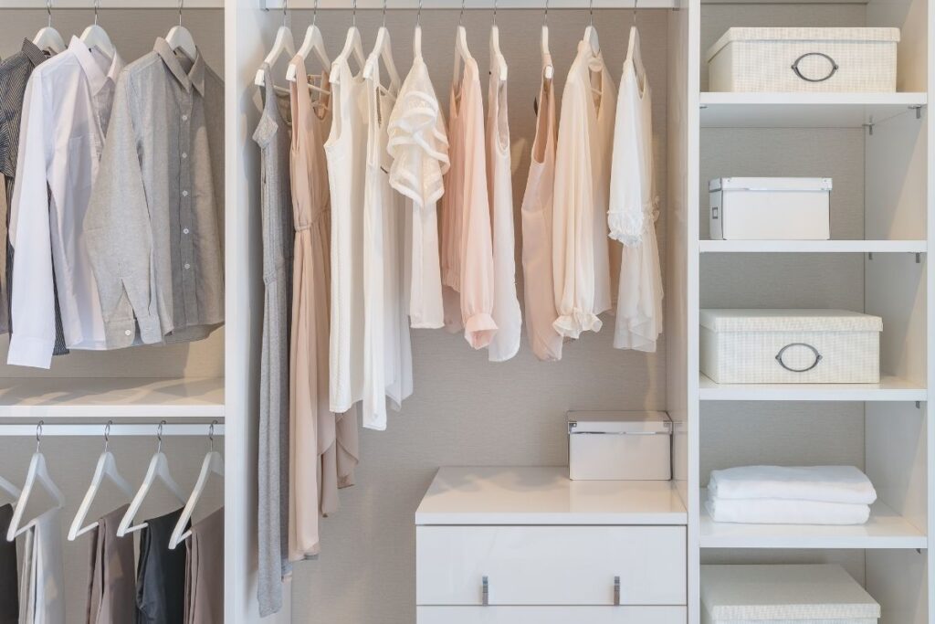 white-walk-in-closet-with-white-hangers-and-white-storage-boxes