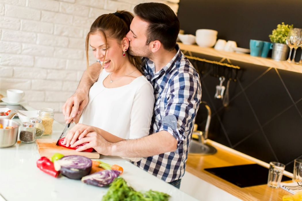 young couple cooking in kitchen