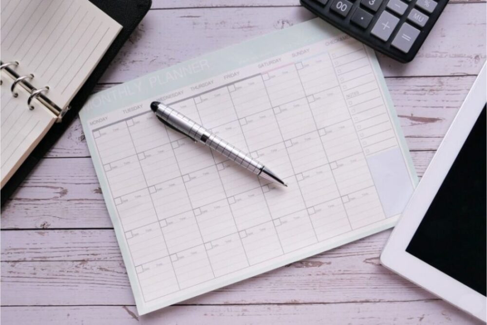 paper planner white wash wood background