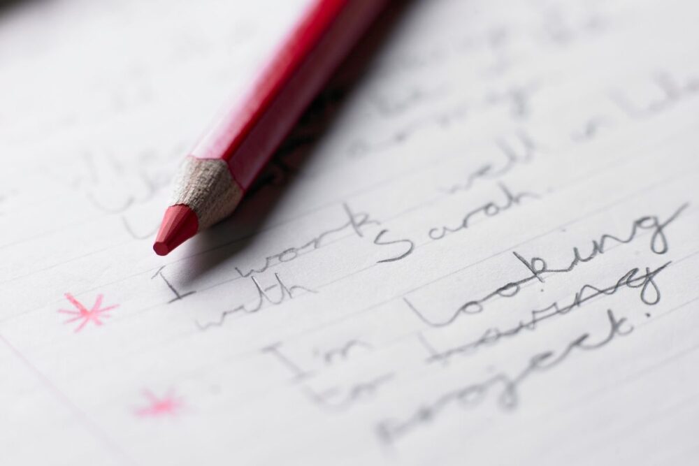 red pencil and lined paper