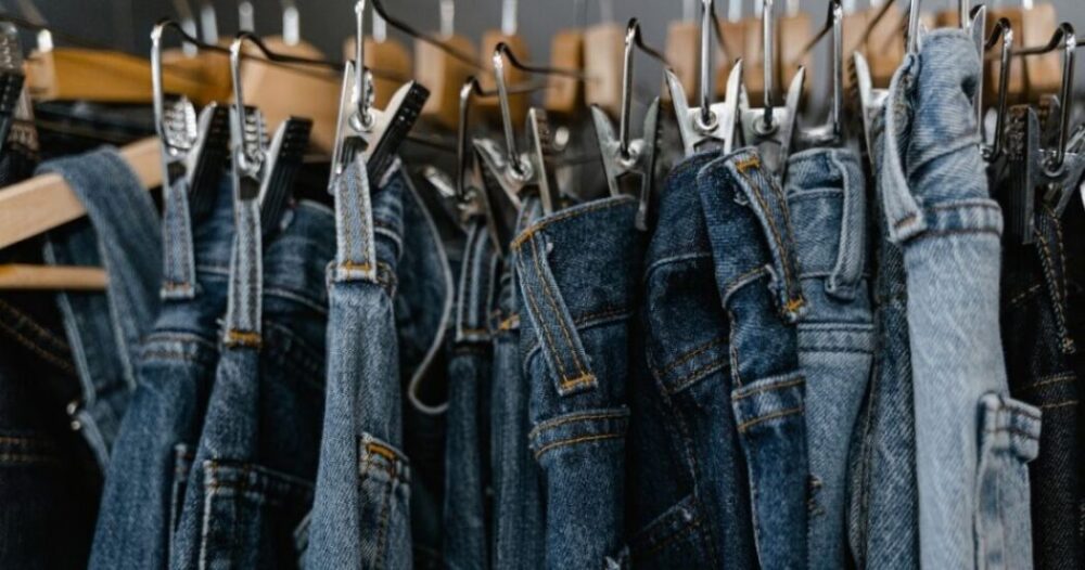 Close-Up Photo of Denim Jeans on a Clothing Rack