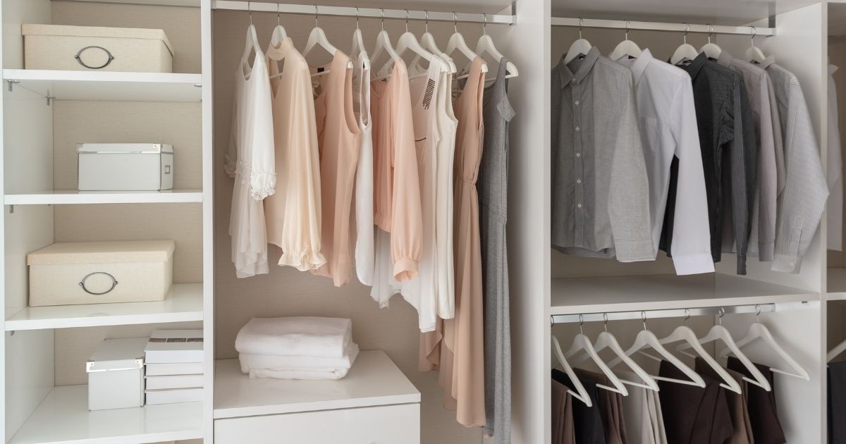 White Organized Closet Neutral Clothes on Hangers