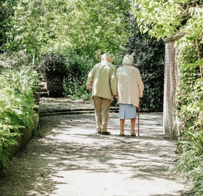 Elderly couple taking a walk through the park