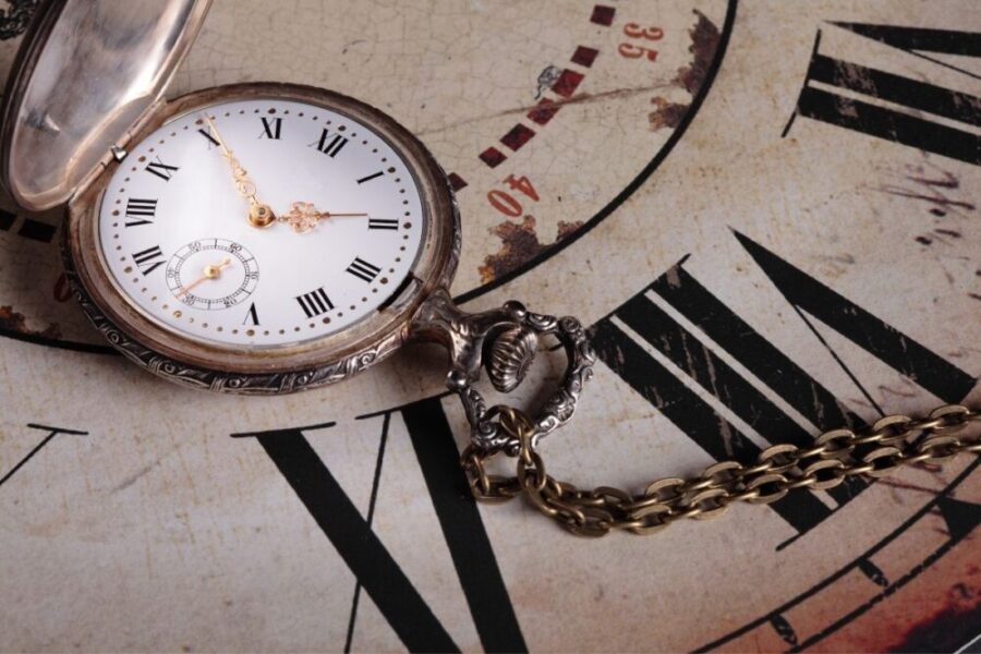 Antique pocket watch on vintage clock