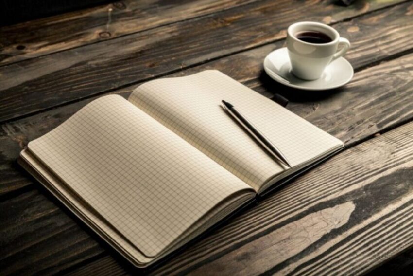 Coffee Notebook Pen on Dark Wood Desk