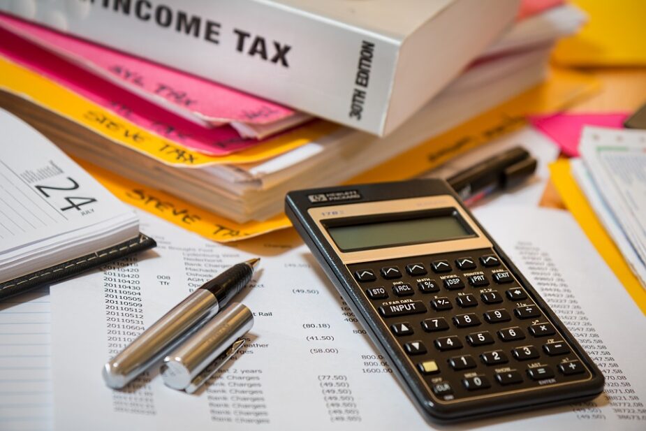 calculator pen financial paperwork income taxes