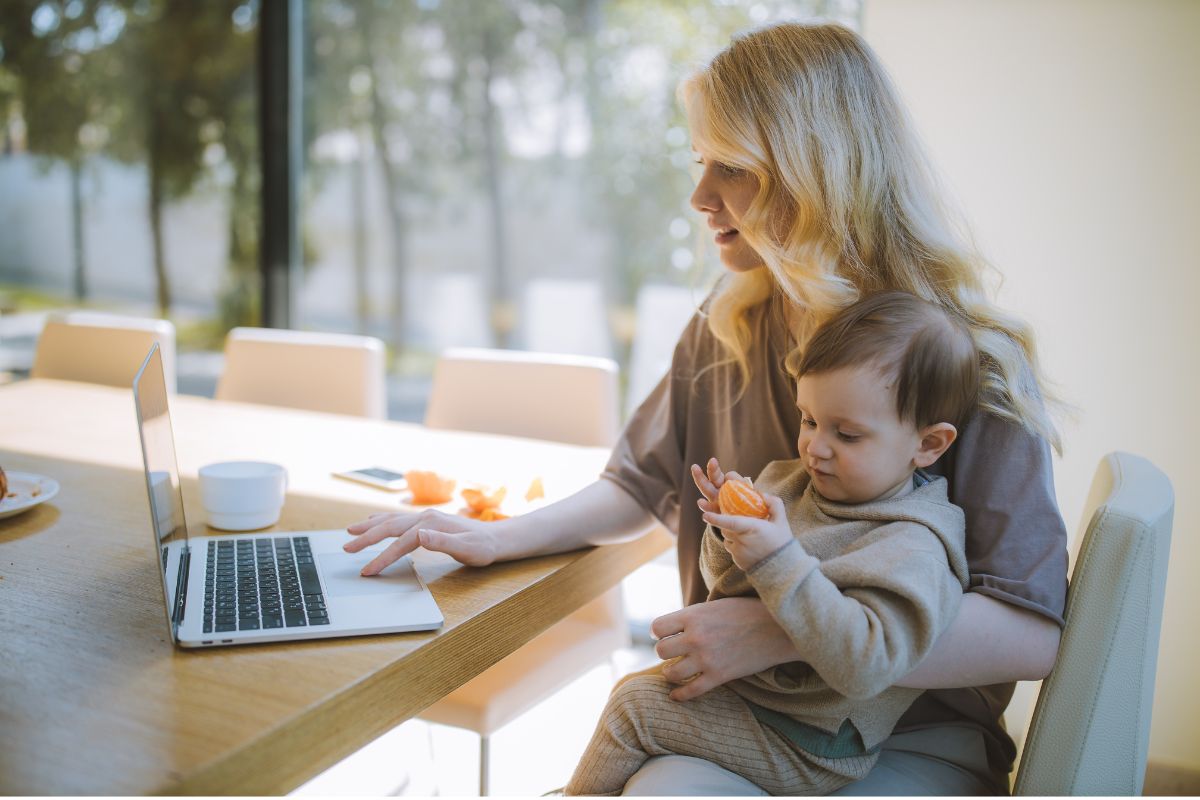 Mom working on laptop with baby