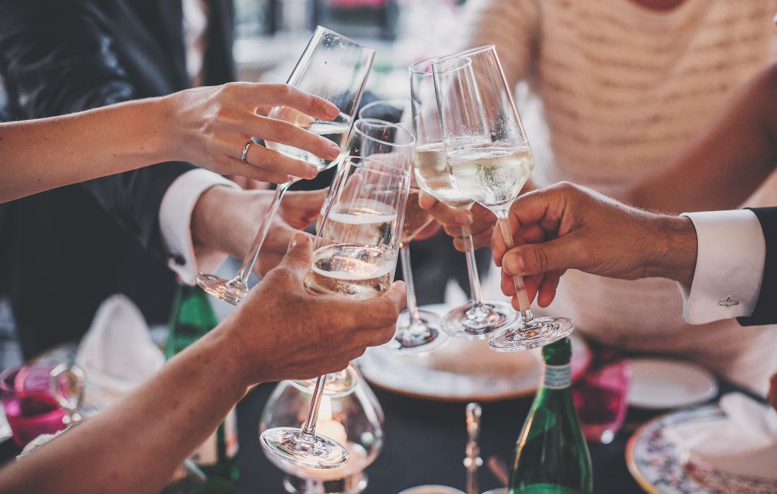 A group of people clinking glasses together in a toast.