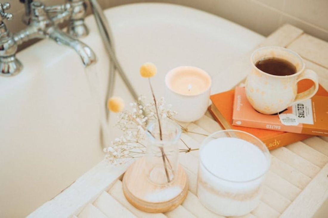 bathtub tray with books coffee and candle