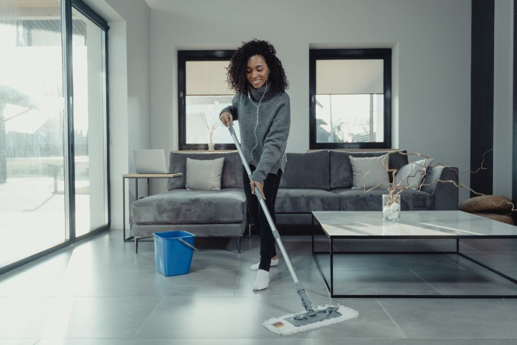 woman listening to music mopping floor