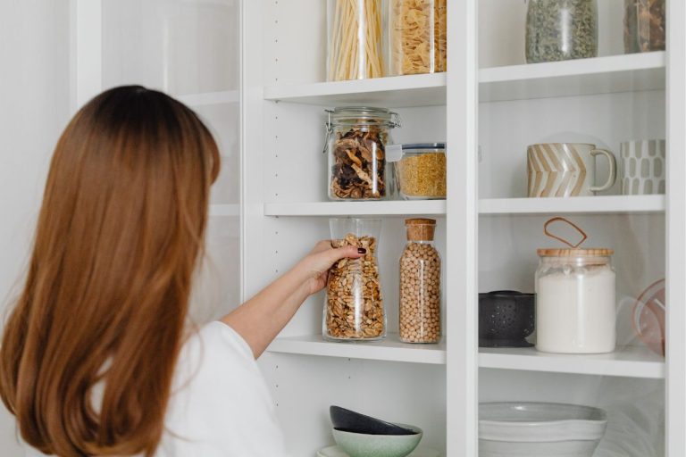 woman organizing pantry shelves
