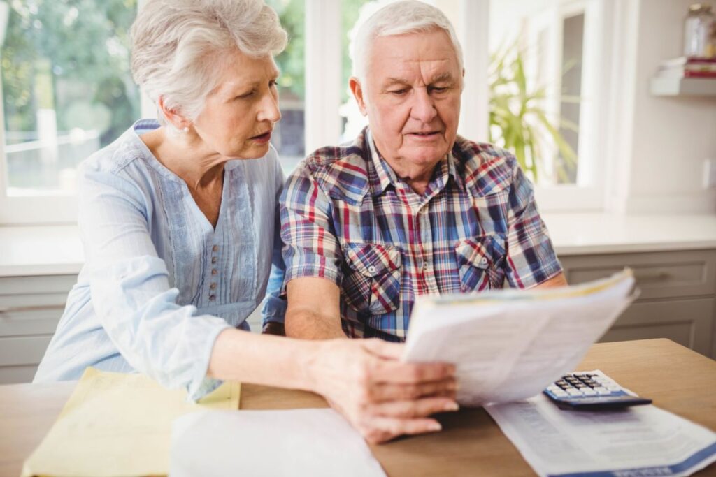 Older adults paying their bills and looking at a document together