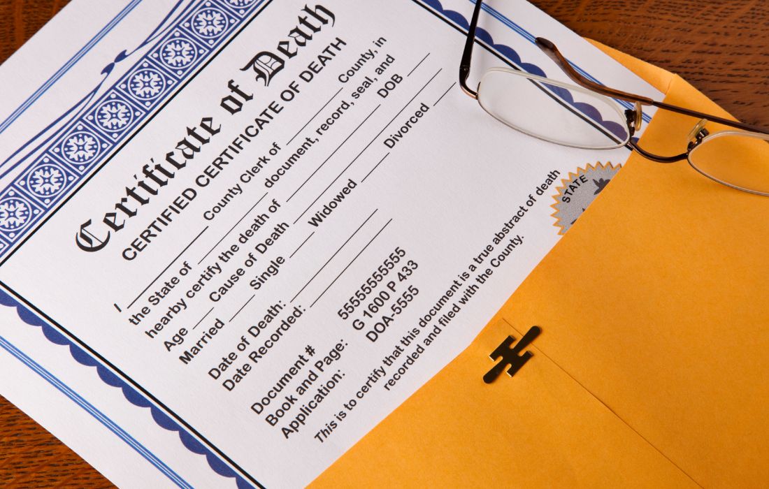 death certificate and eye glasses